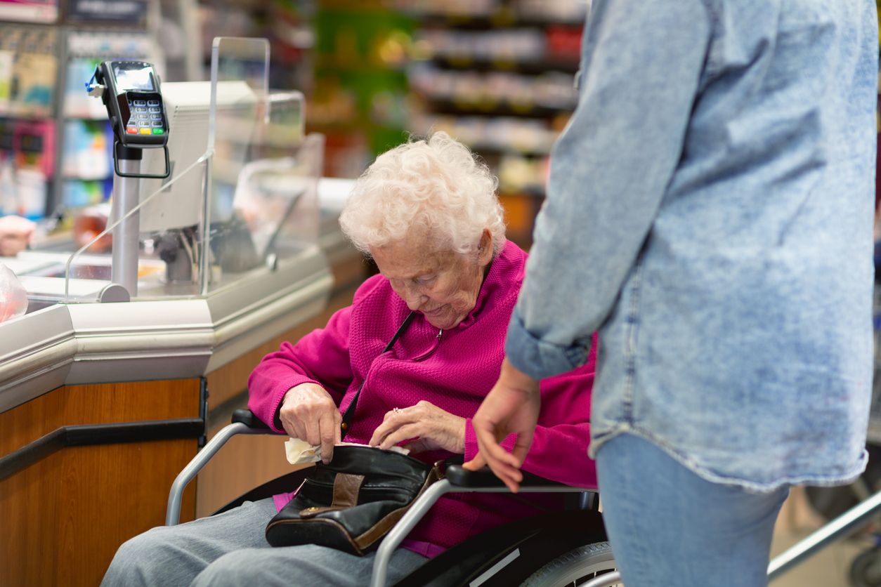 Caregiver helping senior woman with shopping