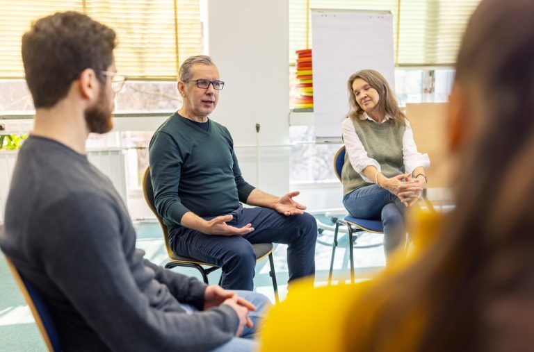 Parents gathered in a circle for an autism support group.