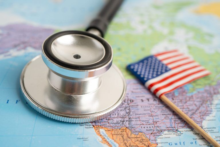 Black stethoscope with USA America flag on world map background, Business and finance concept.