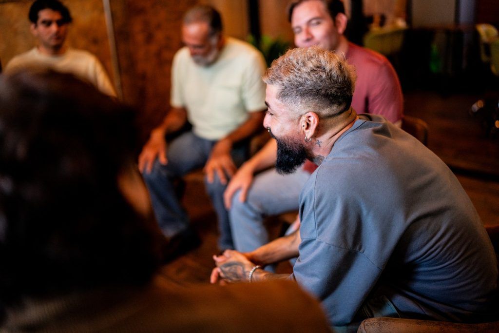 People sitting in a circle during a group support meeting.